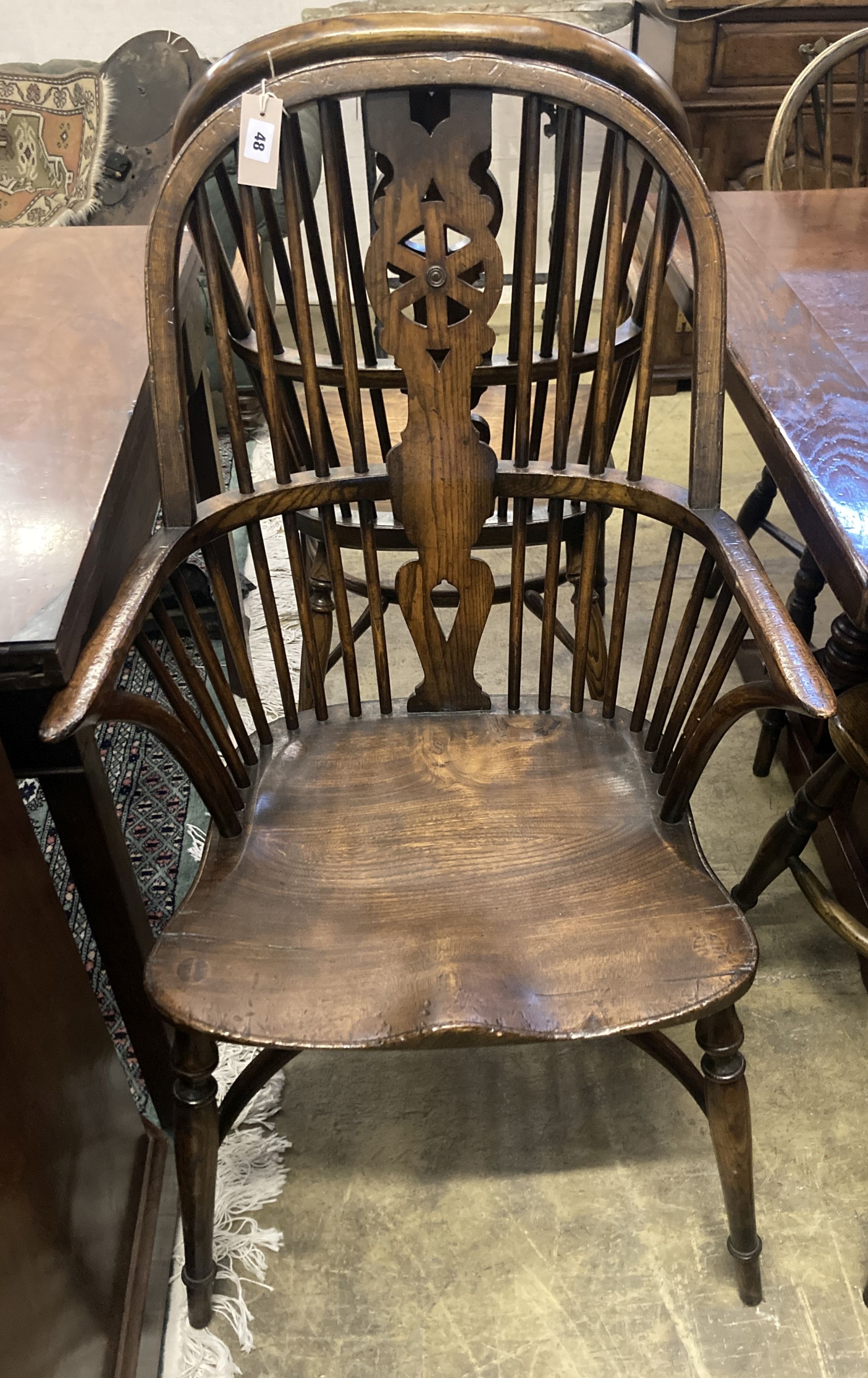 A set of ten stained ash and elm Windsor chairs with crinoline stretchers (two having arms)